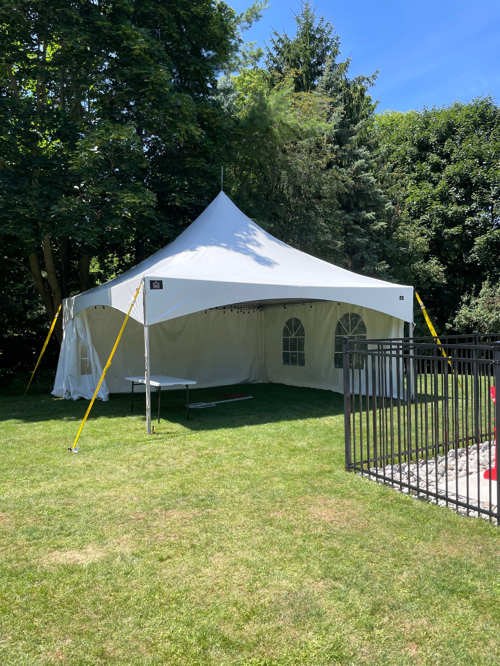 White tent arranged for a backyard birthday celebration