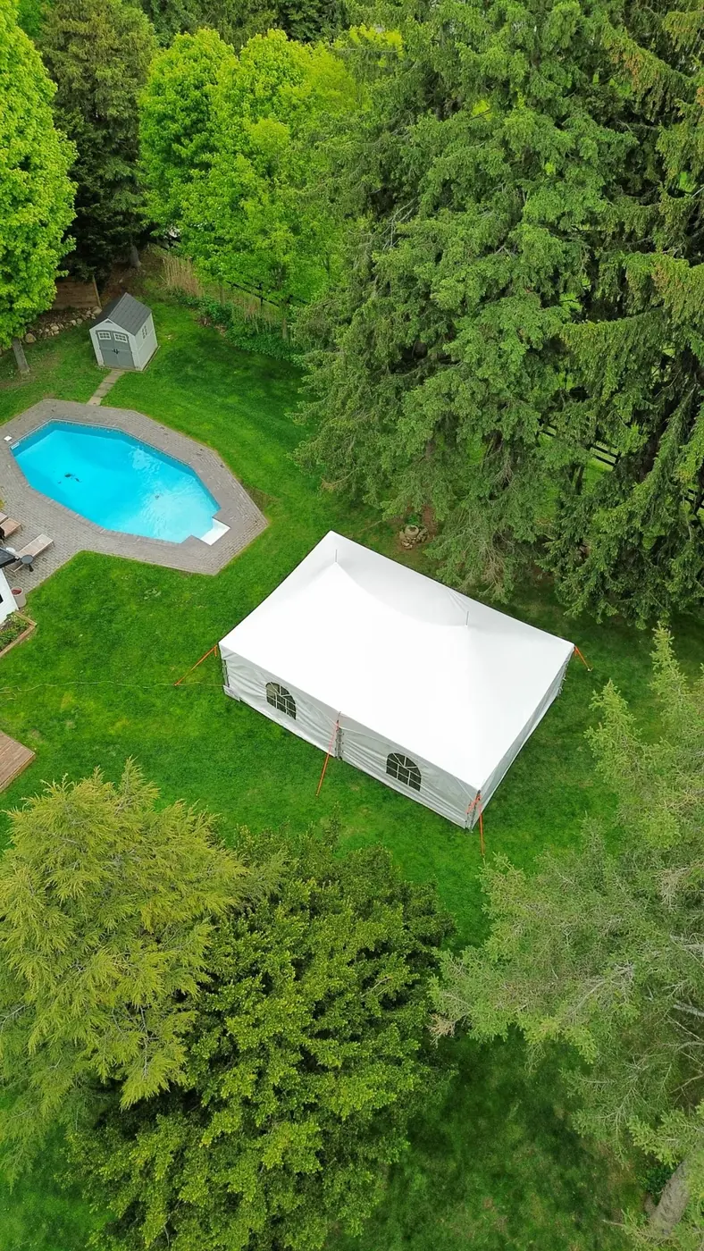 White tent installed in a backyard for a wedding celebration