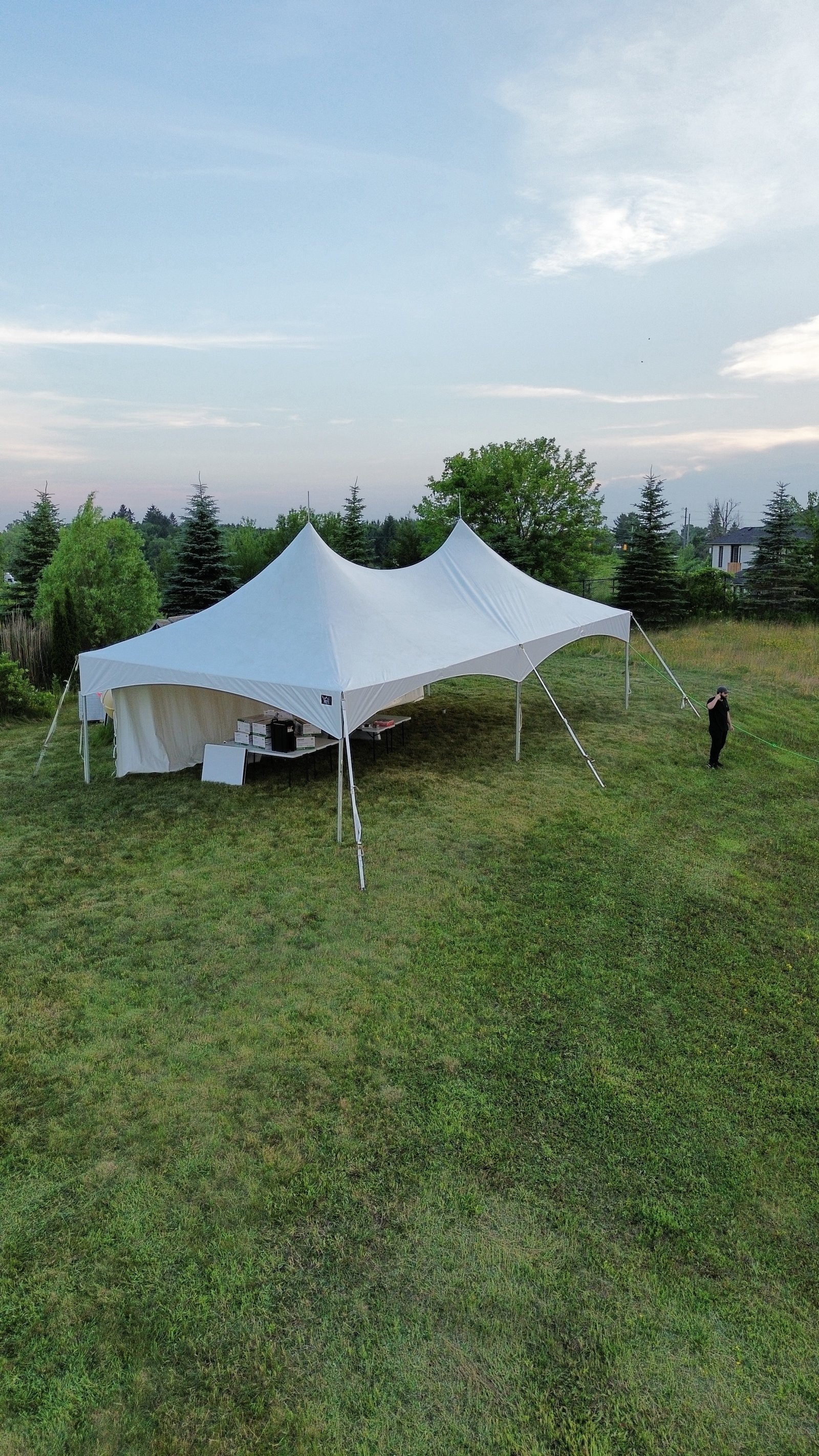 White event tent with dining tables and guest chairs